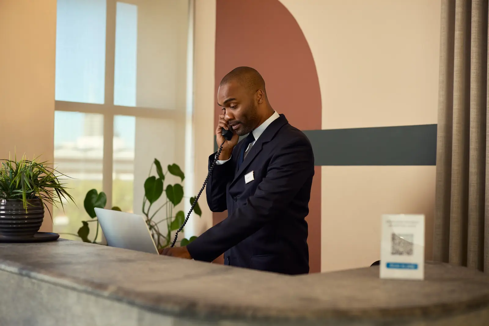 A front desk host on a call